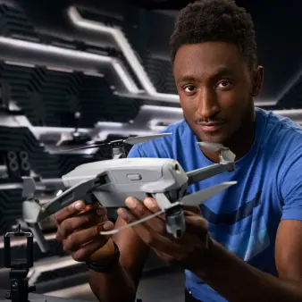 Marques holding a drone. 