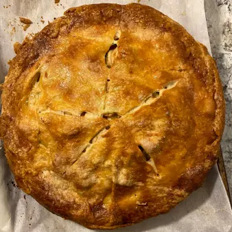 A whole apple pie with golden crust. 