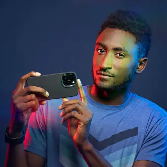 Marques holding a smartphone.