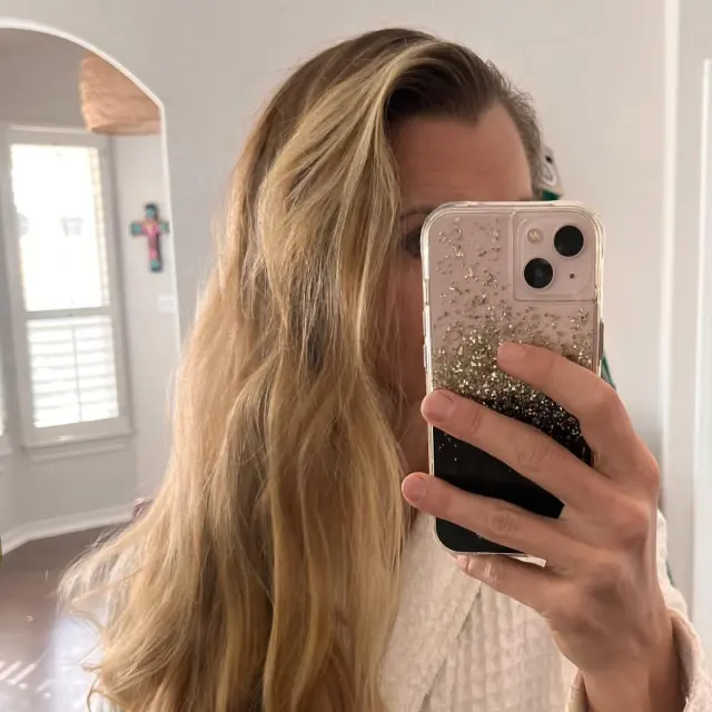 Photo of woman taking selfie with wavy down look hair