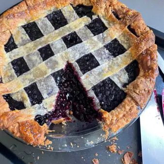 Blueberry pie with a slice cut-out.